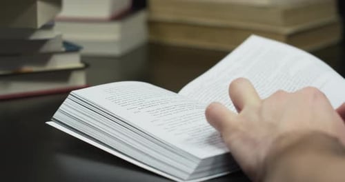 Hand Turning Pages of Book with Pictures