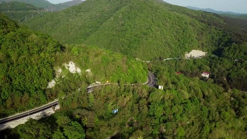 Aerial View of a Curved Winding Road Through the Mountains