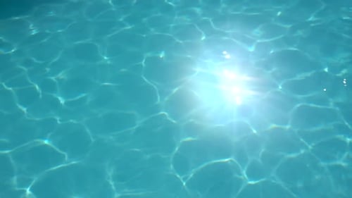 Abstract waves rippling in a pool at a hotel resort.