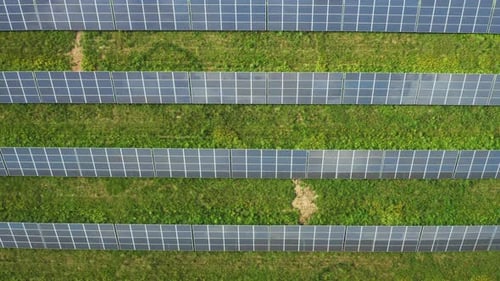 Long Rows of Photovoltaic Sun Panels Installed on Field