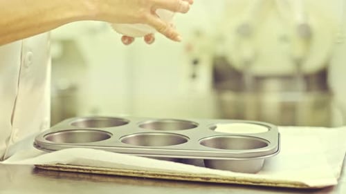 Baker Preparing Muffin Tin with Cupcake Liners