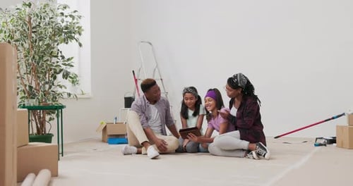 Family Looks at Tablet in New Home