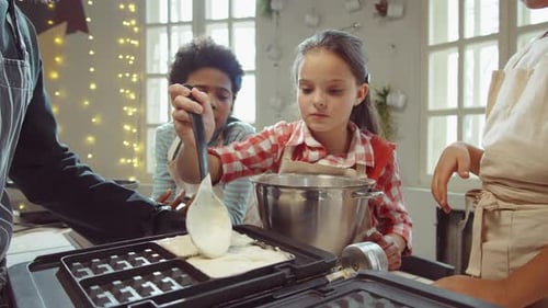 Children Making Waffles with an Adult Chef