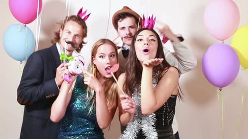 Beautiful friends having fun in party photo booth