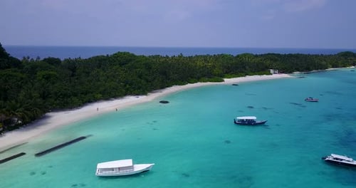 Wide overhead tourism shot of a white paradise beach and turquoise sea background in high resolution