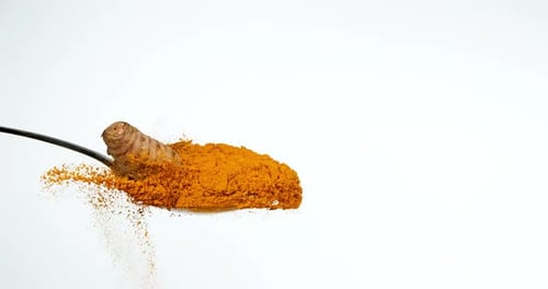 Turmeric, curcuma longa, Root falling on curcuma Powder, Indian Spice, Slow Motion 4K