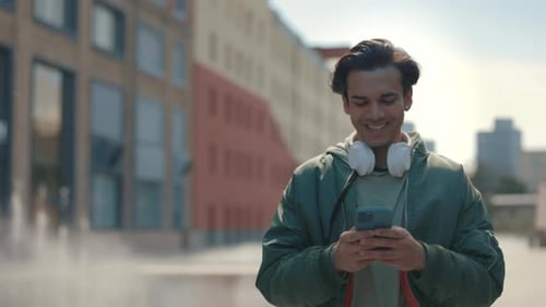 Young Adult Using Phone Outside in the City