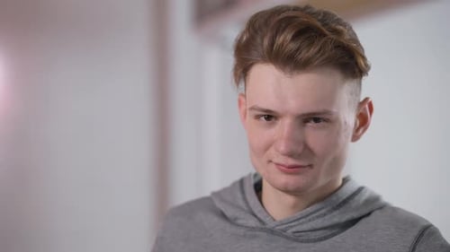 Closeup Portrait of Handsome Confident Caucasian Young Man Looking at Camera Smiling