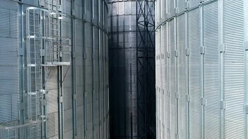 Large metal silo for storing grain. Modern industrial plant. Granary.