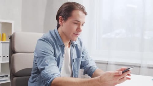 Workplace of freelance worker at home office. Young man works using computer.