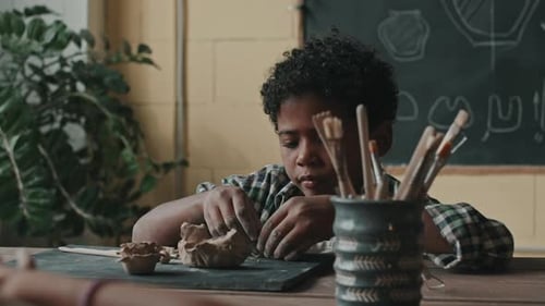 Child Working with Clay in Art Class