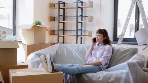 Woman Chatting on Phone After Moving Into New Home