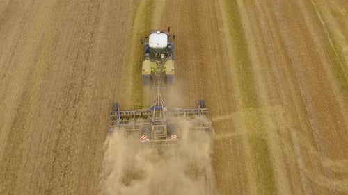 Tractor plows the field aerial.