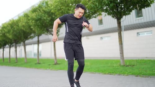 Man Experiences Knee Pain While Exercising Outdoors