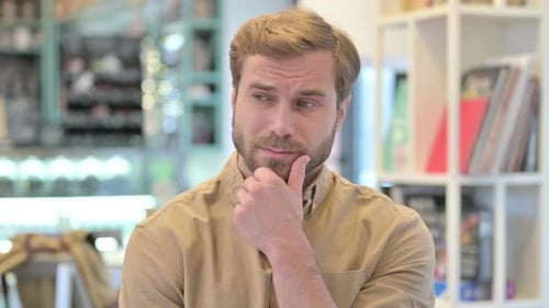 Man is Thoughtful and Looks Around