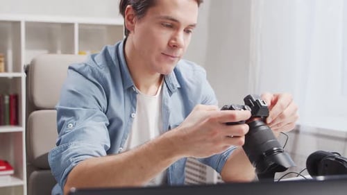 Workplace of freelance worker at home office. Young man works using computer.