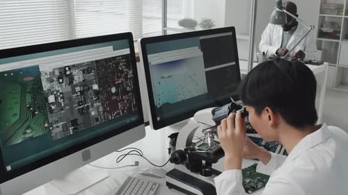 Engineers Inspecting Circuit Boards in Science Lab