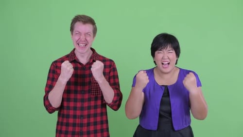 Happy Young Multi Ethnic Couple Getting Good News Together