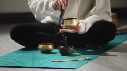 Smoldering Incense and a Person Conducting a Ritual Before Meditation