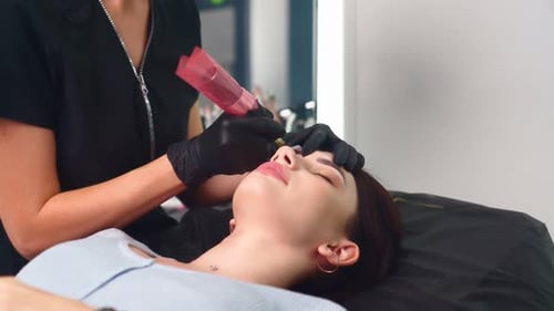 Woman Receiving Cosmetic Eyebrow Tattoo