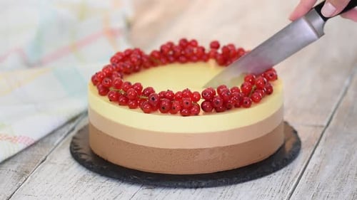 Decorative Cake Being Sliced with Sharp Knife