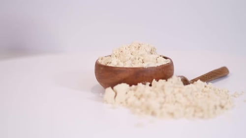 Bowl of White Powder With Wooden Spoon