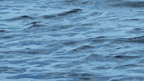 Slow Motion Close-up of Disturbed Blue Ocean Water Surface.