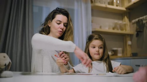 Mother and Child Drawing Together at Kitchen Table