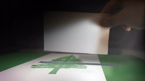 Hand Casting Vote in Ballot Box with Norfolk Island Flag