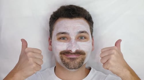 Happy Adult with Facial Mask Gives Thumbs Up