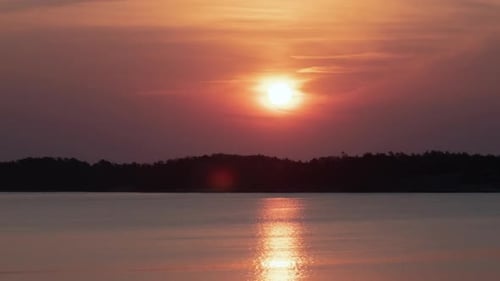 Beautiful Sunrise Over Calm Lake at Golden Hour