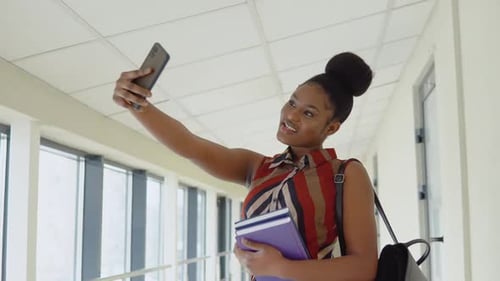 African American Woman Student with a Books in the University