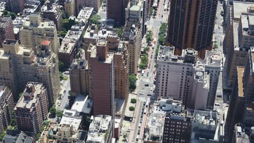 Top view of an urban area of Manhattan on a sunny day with traffic in the streets, static shot.