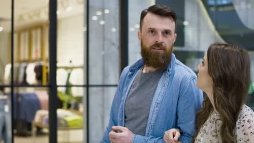 Close up video of couple talking and strolling in shopping mall. Shot with RED helium camera in 8K.