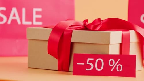 Gift Box and Discount Sign on Table