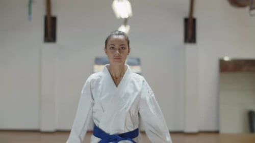 Front View of Serious Girl Performing Basic Karate Stances