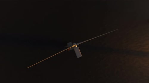 Offshore wind turbines spinning around at the sun setting background. Closeup