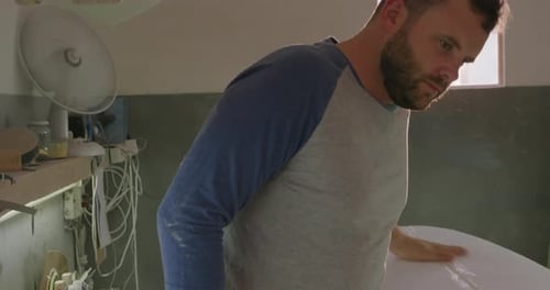 Male surfboard maker in his workshop