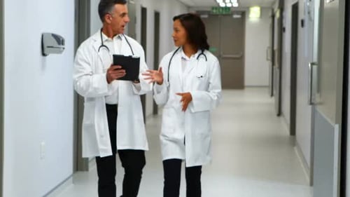 Doctors Discussing Patient Care in Hospital Corridor