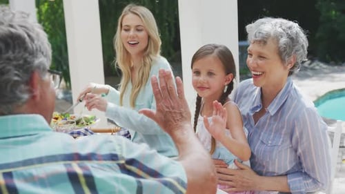 Family Enjoys Outdoor Lunch Together on Sunny Day