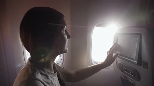 Woman Chooses Music Program in Liner Passenger Cabin Closeup