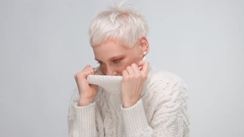 Blonde Model in Turtleneck Sweater Posing