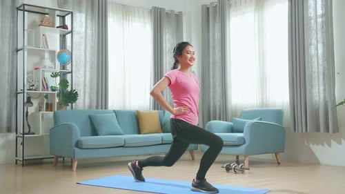 Asian Fitness Girl In Sportswear Is Doing Forward Lunge Exercises In Her Living Room