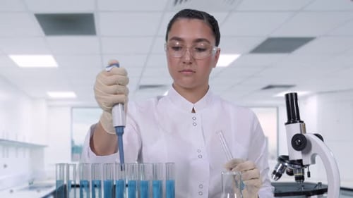 Scientist Working with Pipette and Test Tubes in Lab