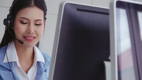 Customer Support Agent or Call Center with Headset Talking to Customer on Phone