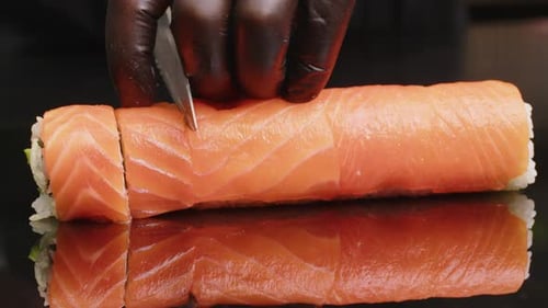 Sushi Chef Slices Sushi on the Sushi Bar