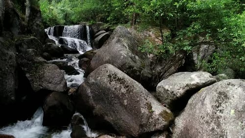 Waterfall surrounded by green nature and trees