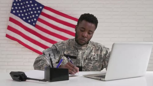 American Soldier in Uniform Working with Laptop in Office
