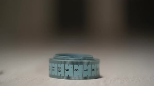 Close Up of a Measuring Tape Being Picked Up