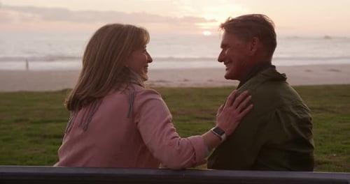 Loving Couple Enjoying Sunset on Beach Bench